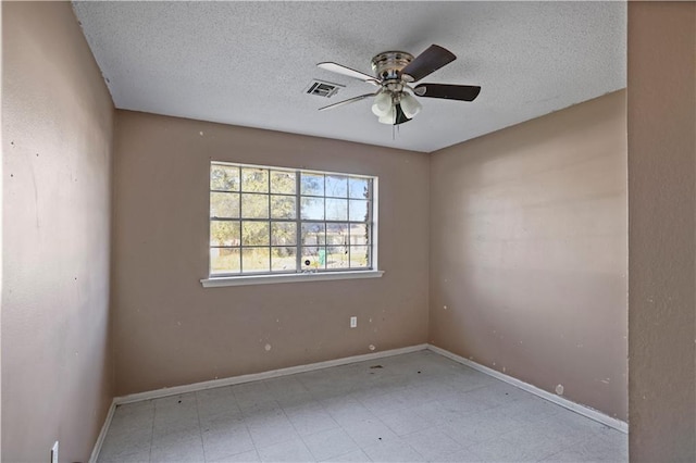 unfurnished room featuring ceiling fan and a textured ceiling