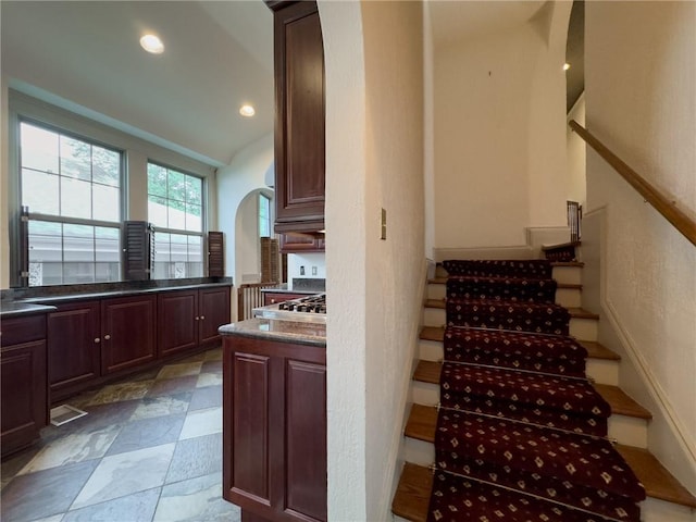 stairway featuring lofted ceiling