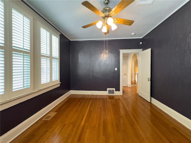 spare room featuring crown molding, ceiling fan, and wood-type flooring