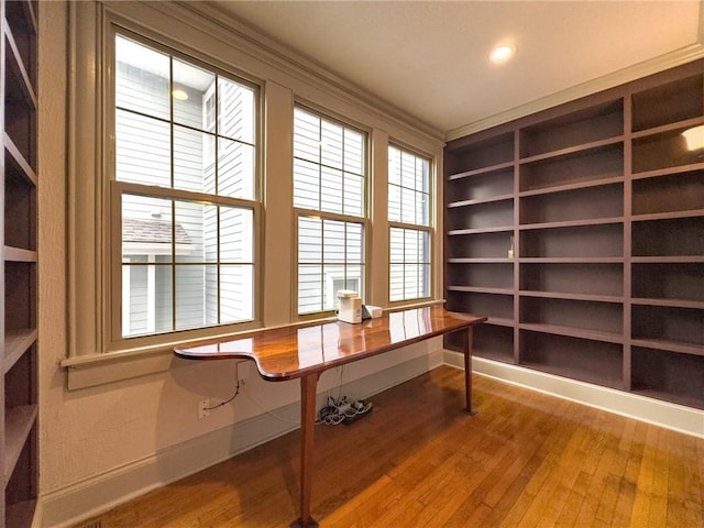 home office featuring hardwood / wood-style floors and ornamental molding