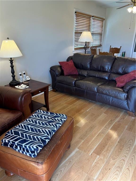 living room with light wood-type flooring and ceiling fan