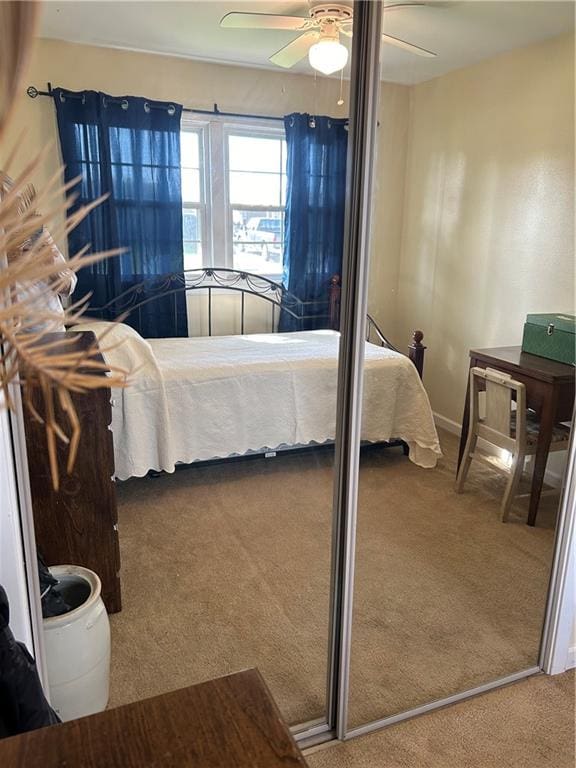 bedroom with carpet flooring, ceiling fan, and a closet