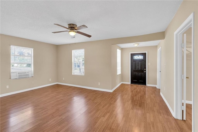 entrance foyer with a textured ceiling, light hardwood / wood-style flooring, plenty of natural light, and ceiling fan