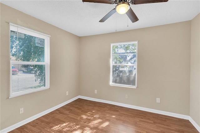 spare room featuring ceiling fan, a textured ceiling, and hardwood / wood-style flooring