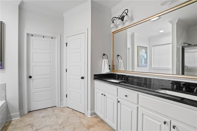 bathroom with vanity, crown molding, and a tub