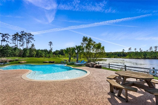 view of pool featuring a patio area, a yard, and a water view