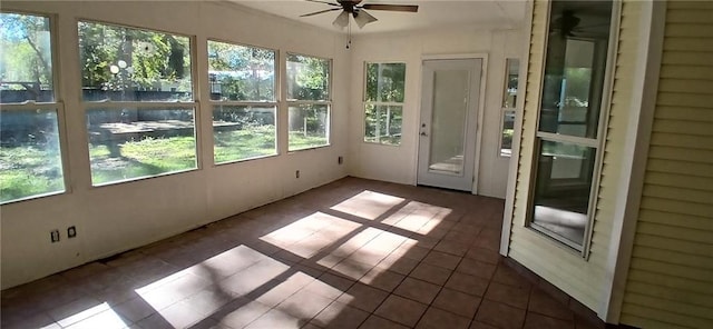 unfurnished sunroom with ceiling fan and a wealth of natural light