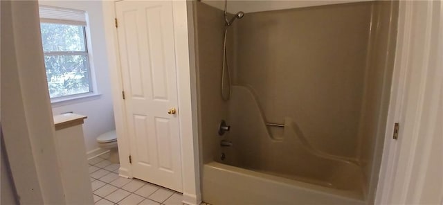 bathroom with tile patterned floors, toilet, and bathing tub / shower combination