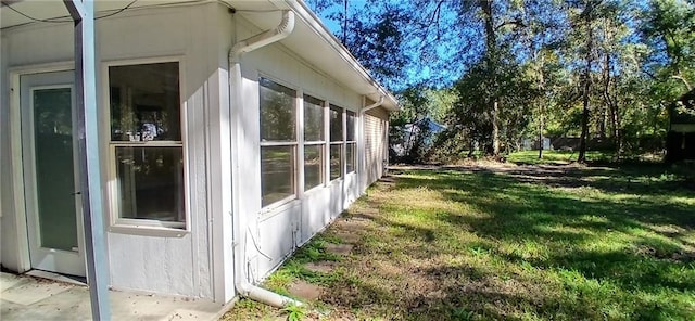 view of side of property with a lawn