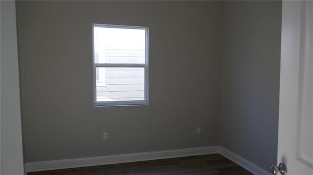 spare room featuring dark hardwood / wood-style floors