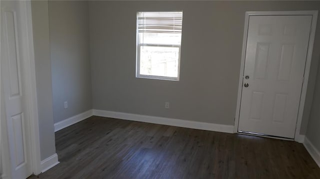 unfurnished room featuring dark hardwood / wood-style flooring