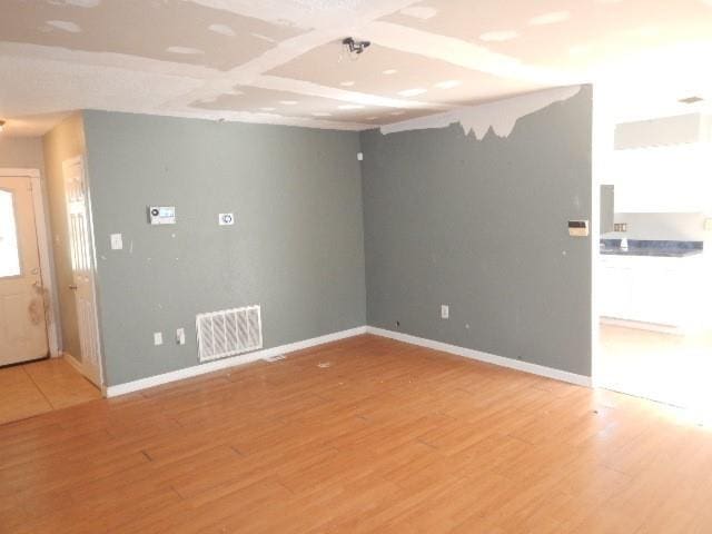 unfurnished room featuring hardwood / wood-style flooring