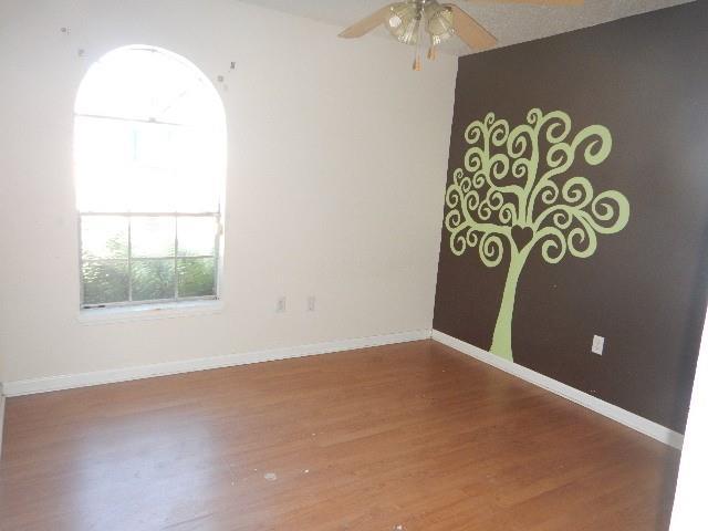 empty room featuring ceiling fan and hardwood / wood-style flooring