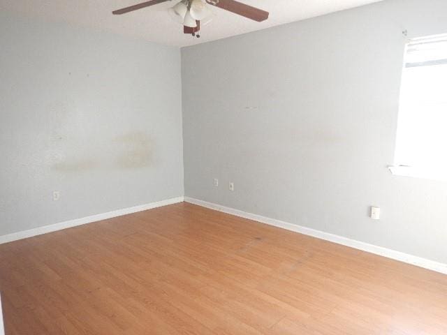 empty room featuring ceiling fan and light wood-type flooring