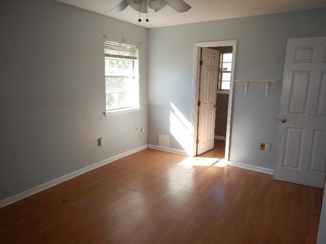 spare room with wood-type flooring and ceiling fan