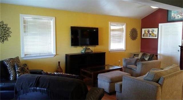 living room with lofted ceiling