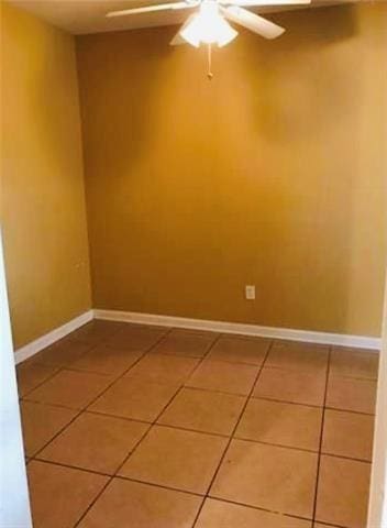 empty room featuring tile patterned floors and ceiling fan