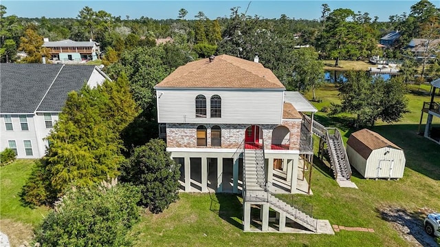 rear view of house with a storage shed