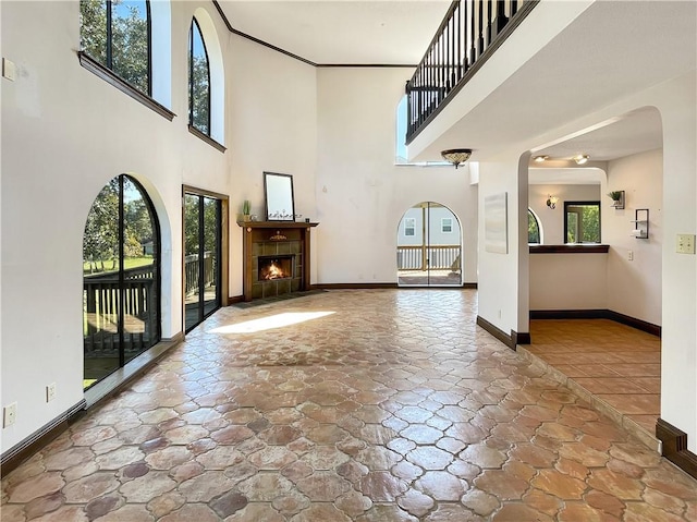 entryway with a fireplace and a high ceiling