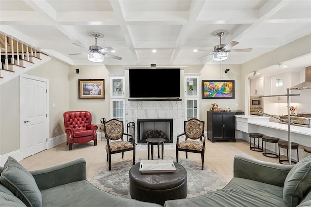 living room featuring beam ceiling, a premium fireplace, light tile patterned floors, and coffered ceiling