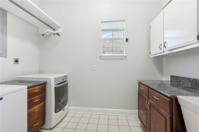 washroom featuring light tile patterned flooring, cabinets, and washer / dryer