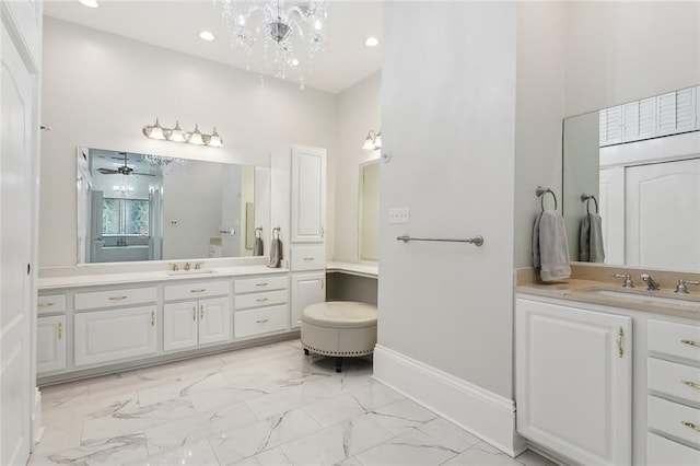 bathroom featuring a towering ceiling, vanity, and a notable chandelier