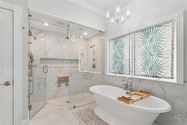 bathroom with separate shower and tub, a chandelier, and tile walls