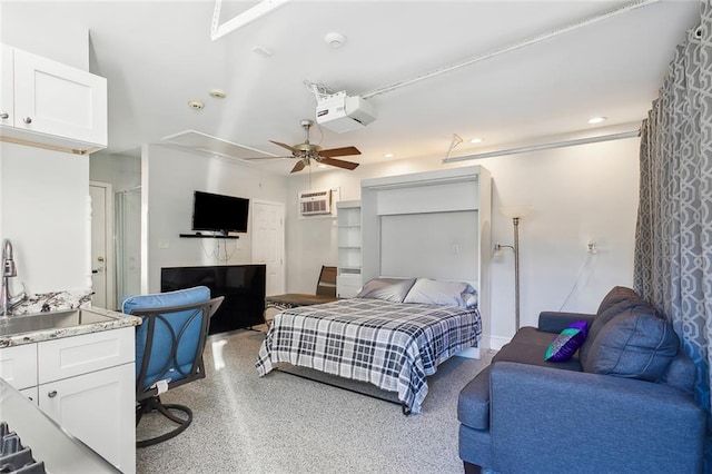 bedroom featuring an AC wall unit, ceiling fan, and sink