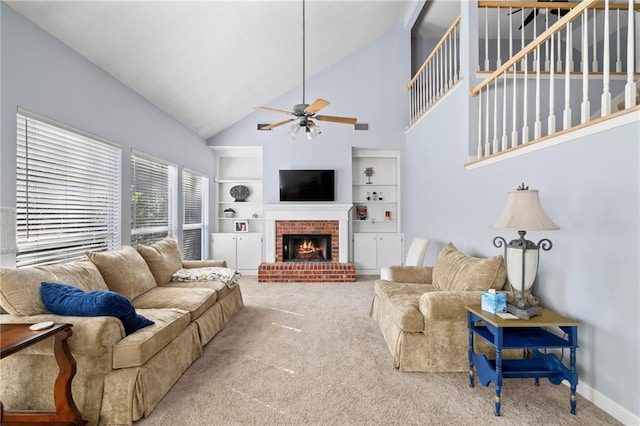 living room featuring ceiling fan, a fireplace, carpet, and high vaulted ceiling