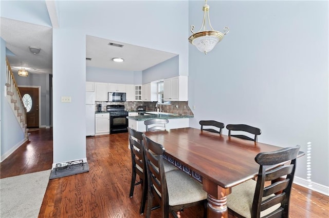 dining area with dark hardwood / wood-style floors and sink