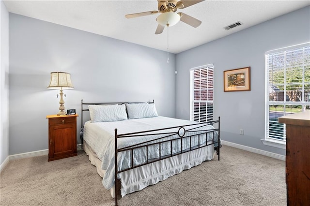 bedroom with ceiling fan and light colored carpet