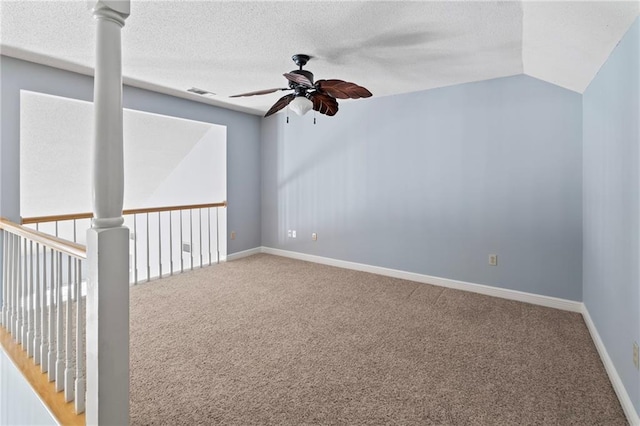 unfurnished room with a textured ceiling, ceiling fan, carpet, and vaulted ceiling