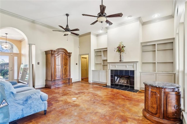 bedroom featuring a towering ceiling, ceiling fan, ornamental molding, and a tiled fireplace