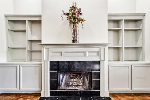 details with a tiled fireplace