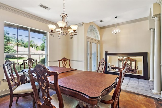 dining room featuring tile patterned flooring, ornate columns, ornamental molding, and an inviting chandelier