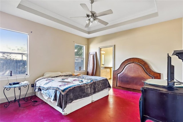 bedroom featuring crown molding, ensuite bath, ceiling fan, a tray ceiling, and carpet floors