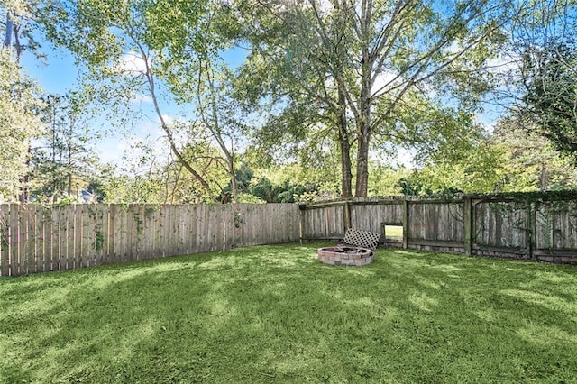 view of yard with an outdoor fire pit