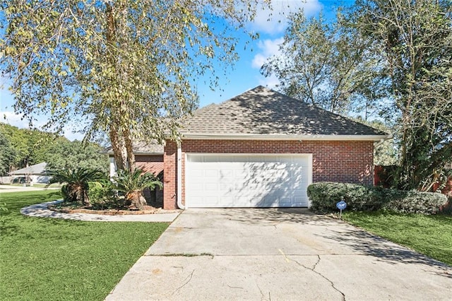 view of side of home with a lawn and a garage