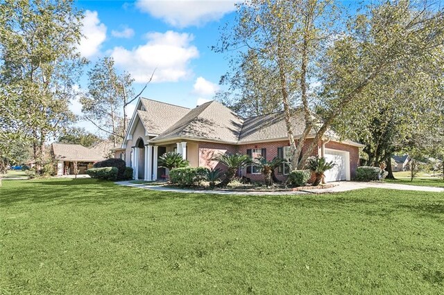 view of front of house with a garage and a front lawn