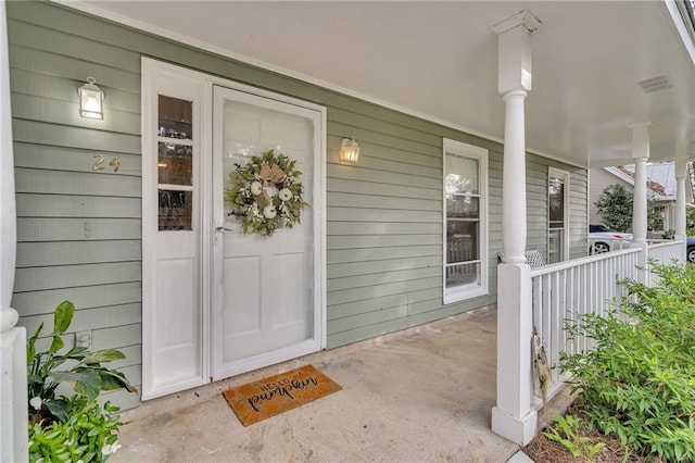 property entrance with covered porch