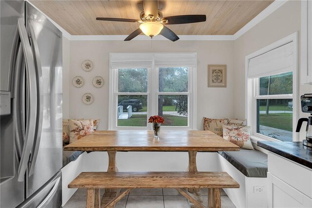 tiled dining room featuring breakfast area, wooden ceiling, and a wealth of natural light