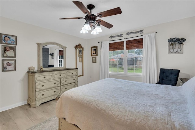 bedroom with light hardwood / wood-style flooring and ceiling fan