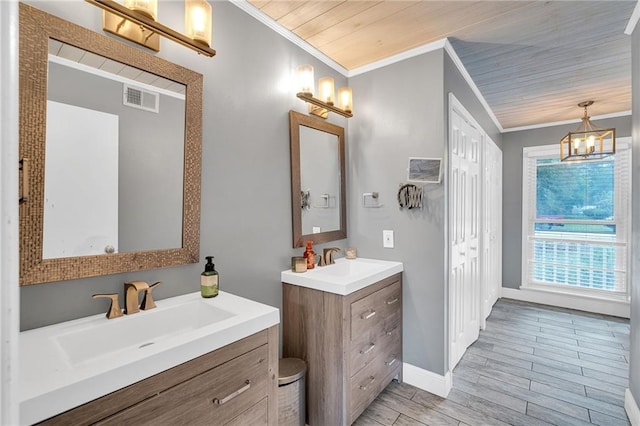 bathroom with wood-type flooring, vanity, wooden ceiling, and crown molding