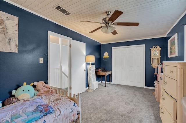 carpeted bedroom with crown molding, ceiling fan, a closet, and wood ceiling