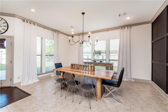 tiled dining room featuring crown molding and an inviting chandelier