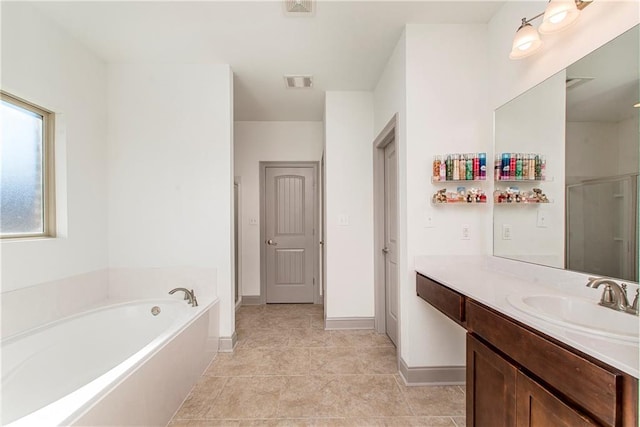 bathroom with tile patterned flooring, vanity, and separate shower and tub