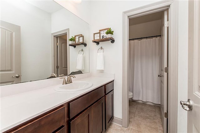 bathroom with tile patterned flooring, vanity, curtained shower, and toilet