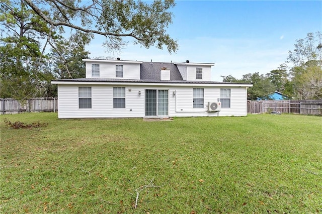 rear view of property with a fenced backyard and a lawn