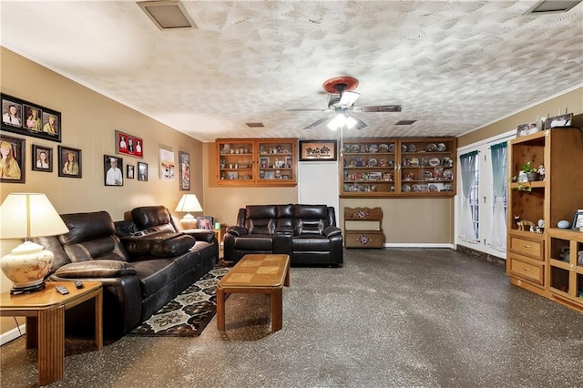 living room featuring ceiling fan and a textured ceiling