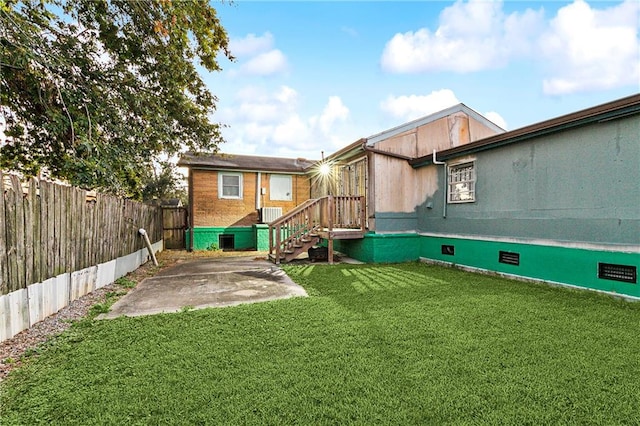 back of house with a patio area and a yard